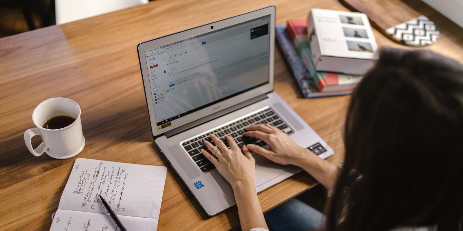 Person working on a Chromebook laptop researching how to unmanage a Chromebook and adjust Chrome OS settings at a desk