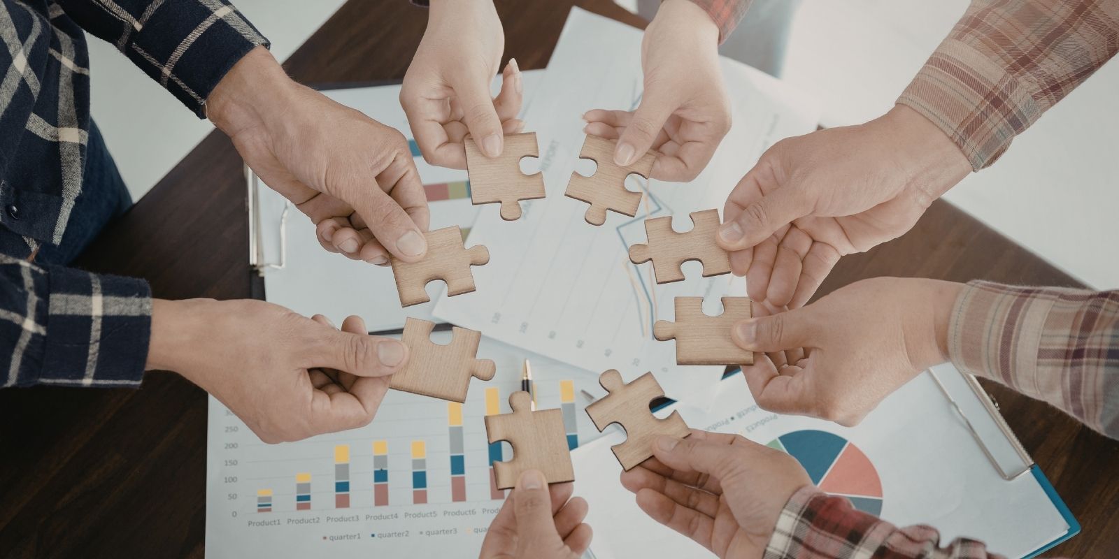 Hands joining puzzle pieces together symbolizing partnership with IT staff augmentation companies and strategic team integration in 2026