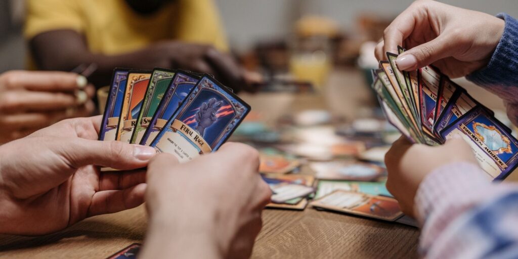 Players sitting around a table playing a strategic card game