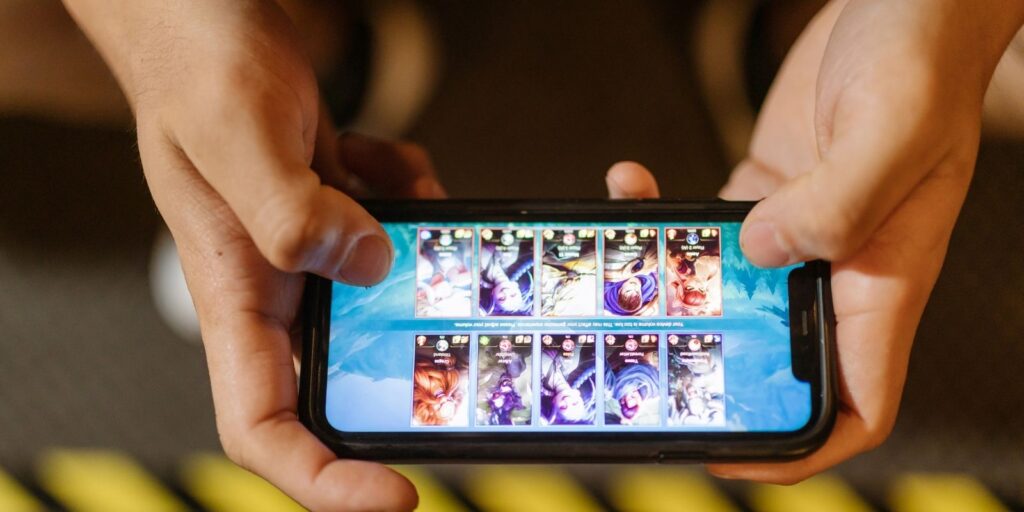 Smartphone displaying character selection menu in a mobile game
