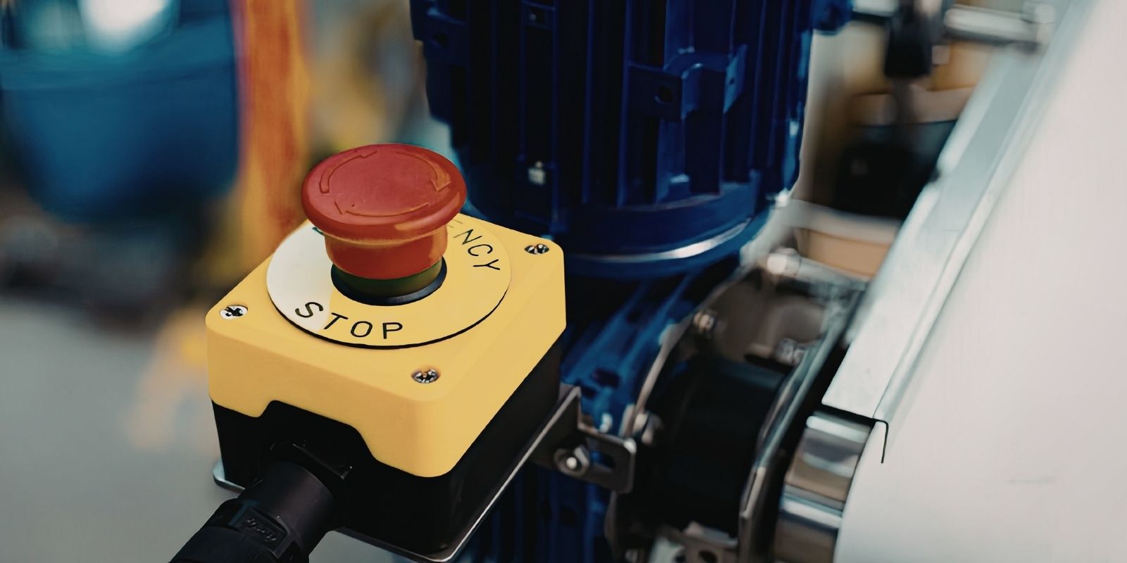 What is a kill switch illustrated by a red emergency stop button on an industrial control panel