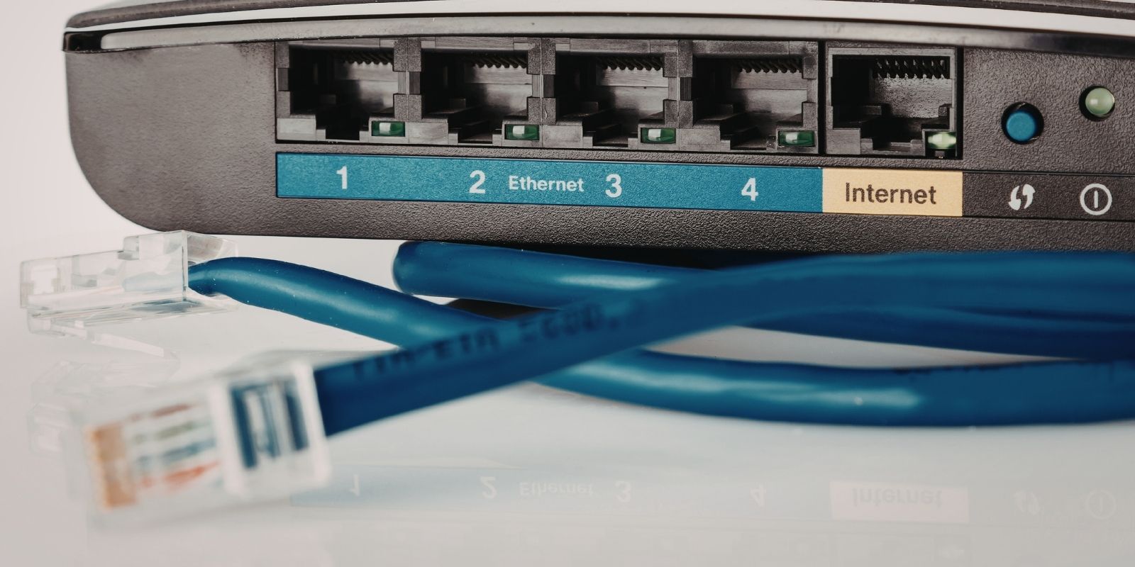 LAN Ethernet cable with RJ45 connectors plugged into a router port for wired network connection