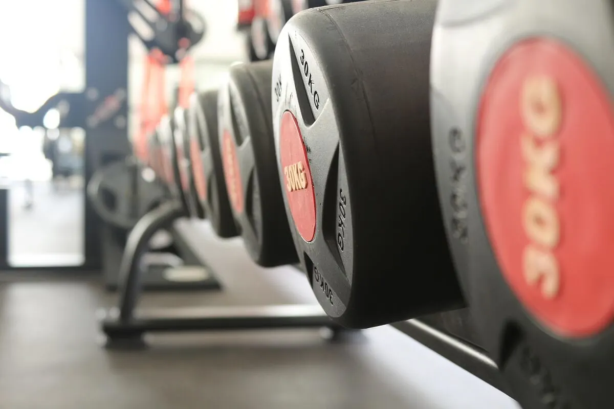 Pair of adjustable dumbbells on a gym floor for home strength training