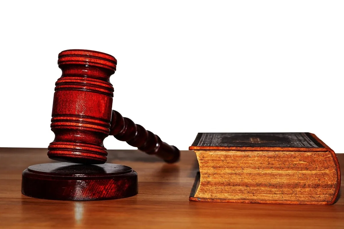 Legal scales and gavel representing the 2026 legal landscape around Glock FRT and handgun forced reset triggers