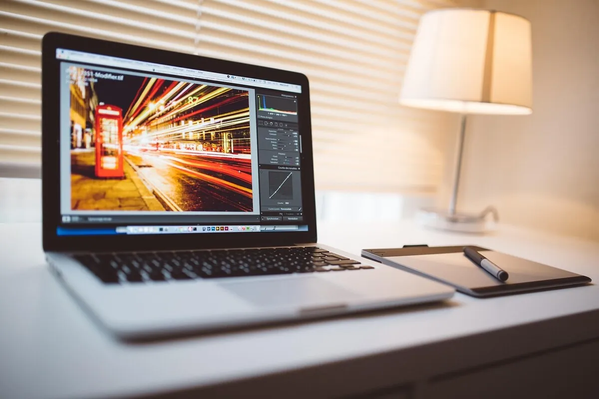 AI photo editing workflow on laptop and mobile representing the Sharp AI photo enhancer ecosystem