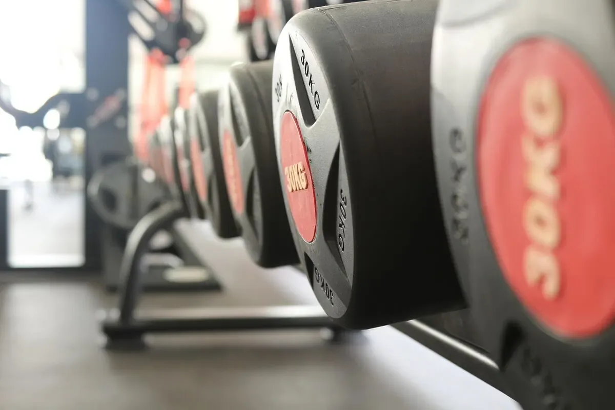 Pair of adjustable dumbbells on a gym floor for home strength training