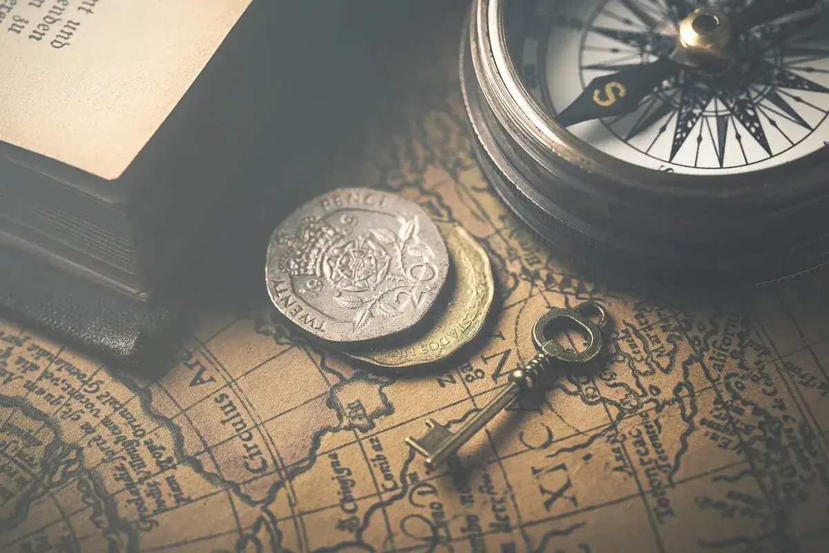 Antiques and collectibles: coins, vintage books, an old compass and map